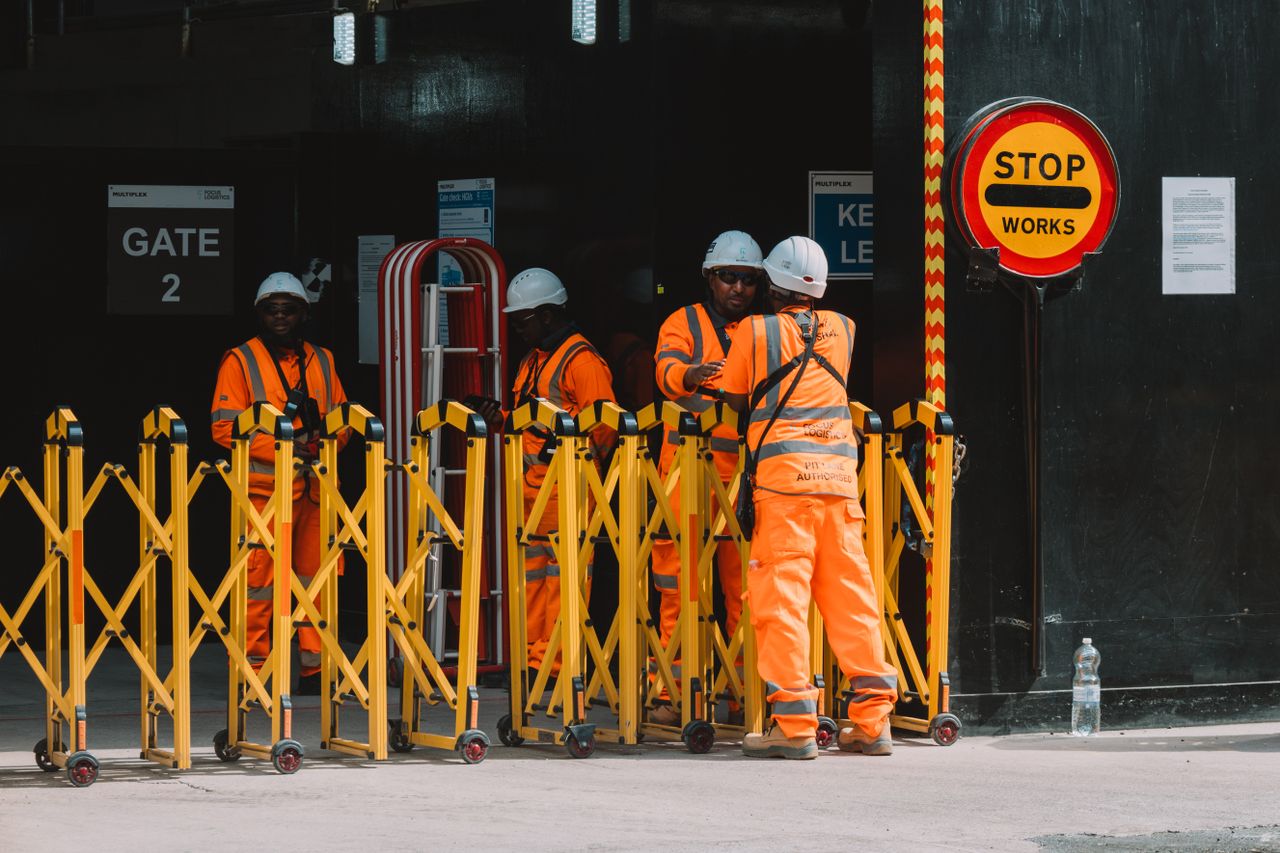 Group of construction workers in safety gear managing a site in London.